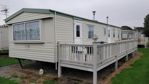 a mobile home with a dog on the deck at 8 Berth Northshore Skegness The Cottage Panel heated in Lincolnshire