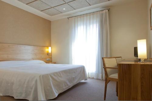 Postel nebo postele na pokoji v ubytování Hotel Bulevard