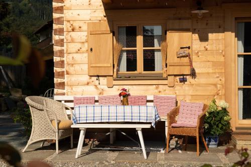 a table and chairs in front of a house at Alchemilla in Bad Feilnbach