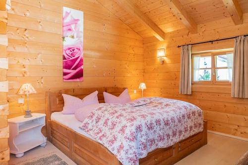 a bedroom with a bed in a log cabin at Alchemilla in Bad Feilnbach