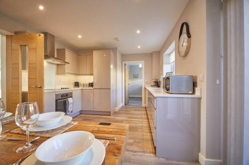 a kitchen with two white bowls on a table at Host & Stay - Sunflower Cottage in Seahouses