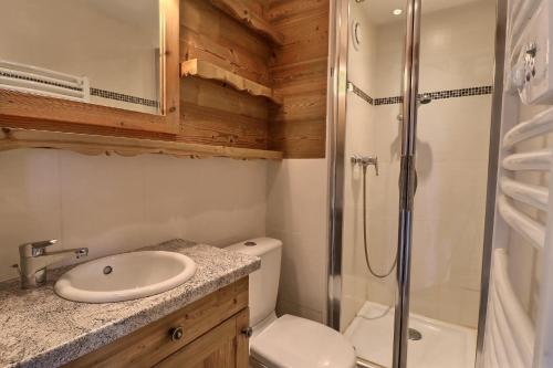 a bathroom with a toilet sink and a shower at Résidence Roc De Tougne in Méribel