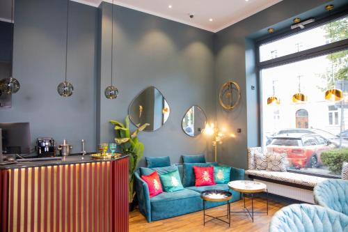 a living room with a couch and a table at Munich Rooms Hotel in Munich