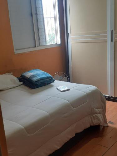 a bed in a room with a pillow on it at ALVORADA PLACE in Santo André