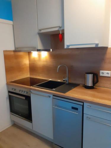 a kitchen with a sink and a stove at Moderne Ferienwohnung in Lippstadt Zentrum in Lippstadt
