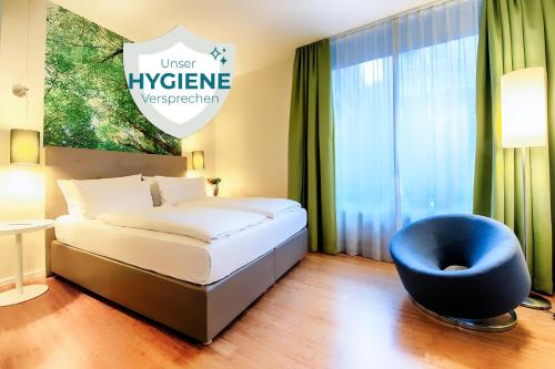 Łóżko lub łóżka w pokoju w obiekcie ACHAT Hotel Bremen City