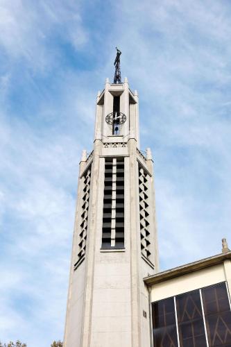 a clock tower with a statue on top of it at Le Grand Albert 1er in Maisons-Alfort