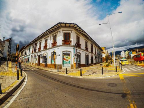 a large white building on a street with a road at Casona Hotel in Pasto