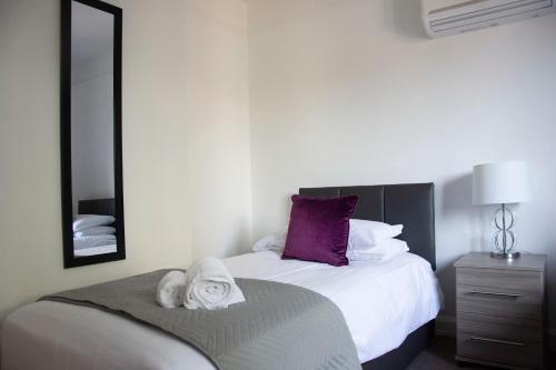 a bedroom with a bed with towels on it at Friarscroft Lodge Holiday Home in Wymondham