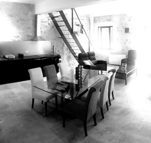 une salle à manger avec une table et des chaises en verre dans l'établissement MAS TAREAU Le CHAI, à Beaucaire