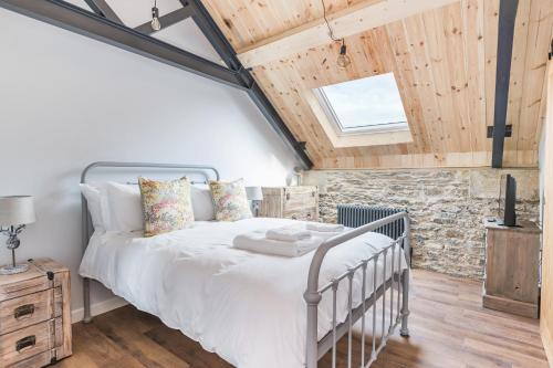 a bedroom with a bed and a stone wall at Kingston Estate in Staverton