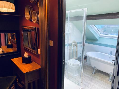 uma casa de banho com uma banheira, um WC e um lavatório. em Minster Walk Guesthouse em York