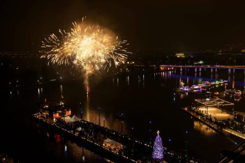 a fireworks display in the water with a christmas tree at InterContinental - Washington D.C. - The Wharf by IHG in Washington