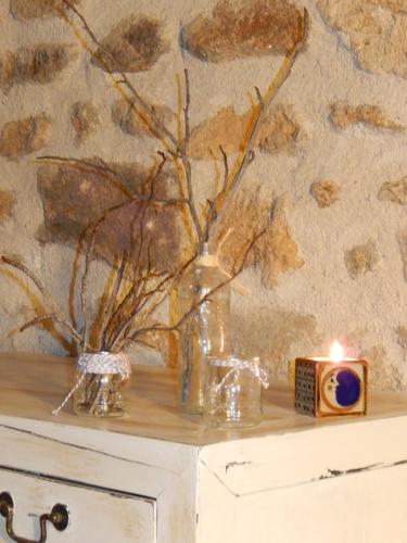 a table with a candle and a vase with flowers at El Turcal in Torremenga