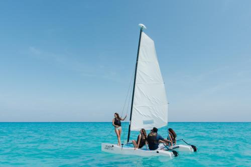 a group of people on a sailboat in the ocean at The Reef Playacar Resort & Spa-Optional All Inclusive in Playa del Carmen