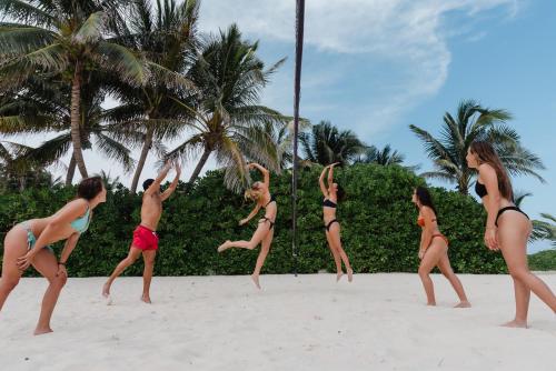 a group of women in bathing suits on a beach at The Reef Playacar Beach Resort & Spa-Optional All Inclusive in Playa del Carmen