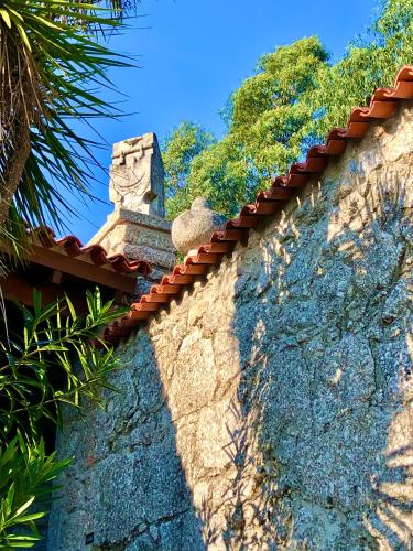 a stone wall with a roof on top of it at Casa do Pomar - Eido do Pomar in Arcos de Valdevez
