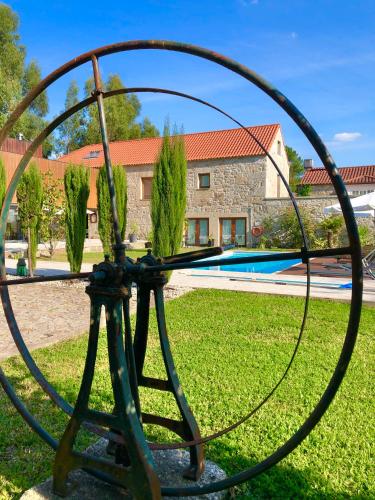 a metal sculpture of a plant in a yard at Casa do Pomar - Eido do Pomar in Arcos de Valdevez