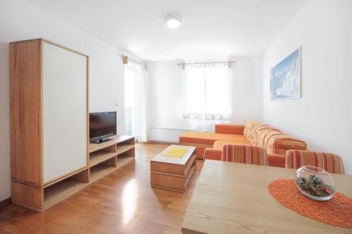 a living room with a couch and a tv at Vila Bjanka in Zlatibor