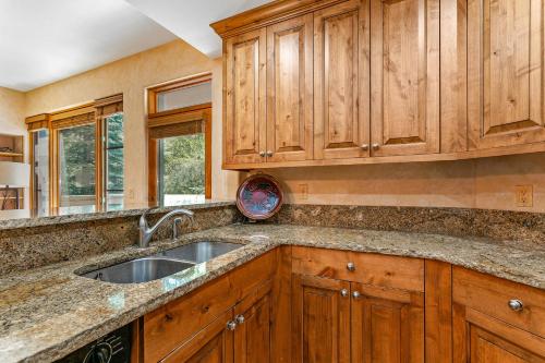 una cocina con armarios de madera y fregadero en Spruce Tree Lodge #208 en Edwards