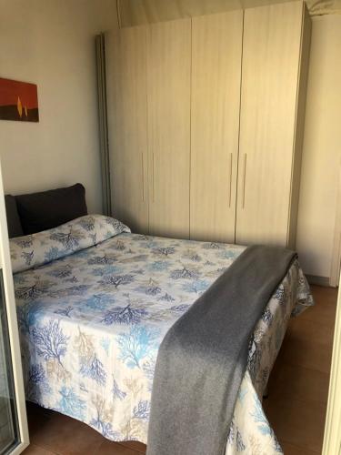 a bedroom with a bed and a cabinet at Pia Beach House in Bacoli