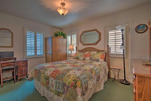 a bedroom with a bed and a desk and two windows at Avalon Escape Everything Within Walking Distance! in Avalon