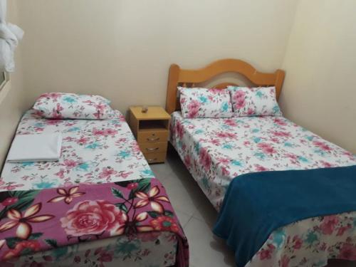 Ein Bett oder Betten in einem Zimmer der Unterkunft Conexão Hostel