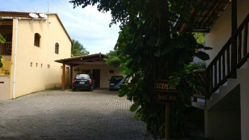 a car parked in a garage next to a building at Pousada Tropicalia in Itaparica Town