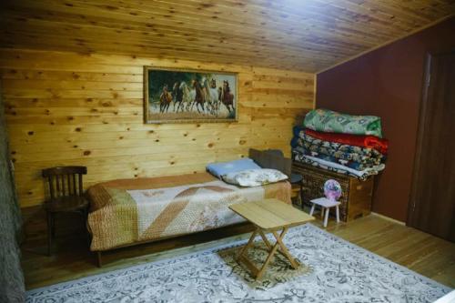 a bedroom with a bed and a table in a room at Family FunHouse in Vorontsovskoye