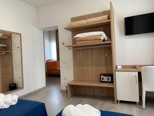 a room with a room with a bed and a tv at Locanda Damaro in Vicenza