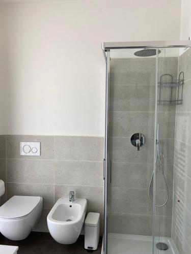 a bathroom with a shower and a toilet and a sink at Locanda Damaro in Vicenza
