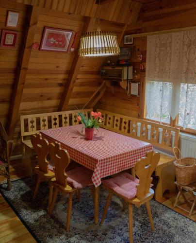a dining room with a table in a cabin at Ethno Cottage "Biljana" in Zlatibor
