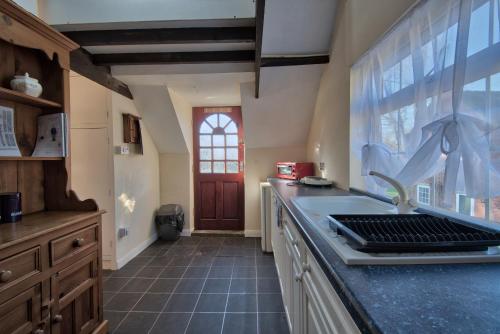 a kitchen with a counter with a sink and a window at 17th-Century1Bed Studio PetsOk Garden Wifi in Elkesley