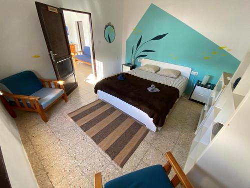 a bedroom with a bed, chair, and desk at joyhouse in Teguise