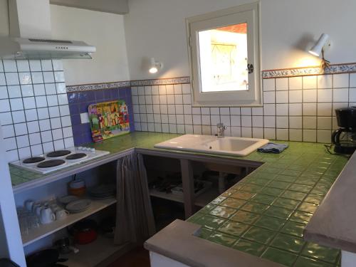 a kitchen with a sink and a counter top at AU PIED DU VENTOUX in Flassan