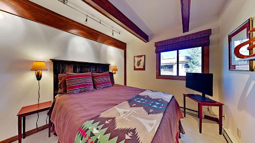 a bedroom with a bed and a flat screen tv at Timberline Condominiums 2 Bedroom Premier Unit C1D in Snowmass Village