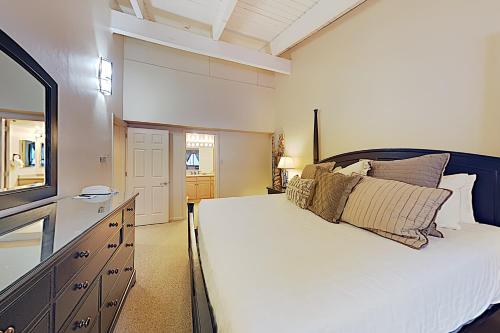 a bedroom with a large white bed and a television at Timberline Condominiums 3 Bedroom plus loft Deluxe Unit D3E in Snowmass Village