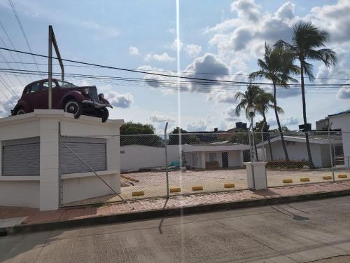 a car is sitting on top of a building at Hotel Manantial Melgar Torre 2 in Melgar