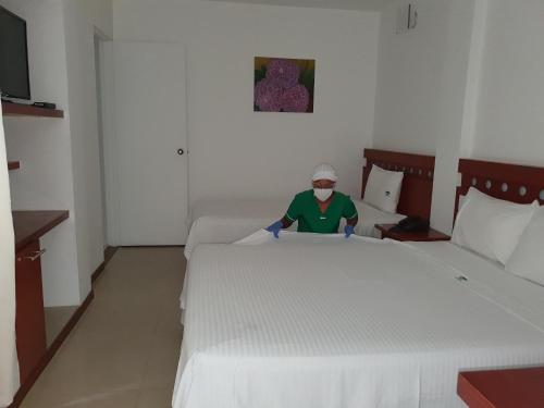 Una cama o camas en una habitación de Hotel Imbanaco