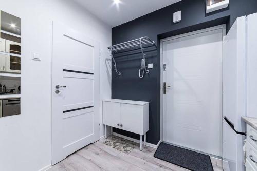 a bathroom with white cabinets and a white door at Apartment L'Orque in Radom