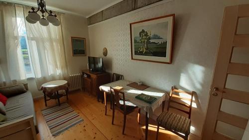 a living room with a table and a dining room at Majakovski Family Suite in Sillamäe