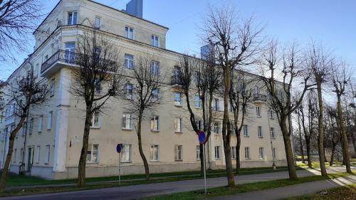 a large white building with trees in front of it at Majakovski Family Suite in Sillamäe