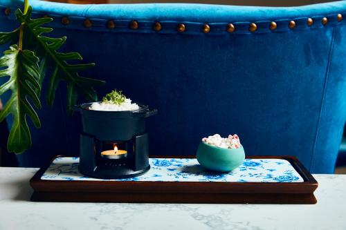 a table with a candle and a bowl of rice at Kimpton Hotel Fontenot by IHG in New Orleans
