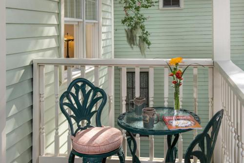 a table with two chairs and a table with a vase on a porch at The Addison on Amelia in Fernandina Beach