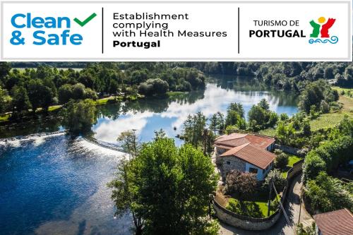an image of a river with a house at Casa do Engenho Braga - Apartamentos com Vista Rio & SPA in Braga