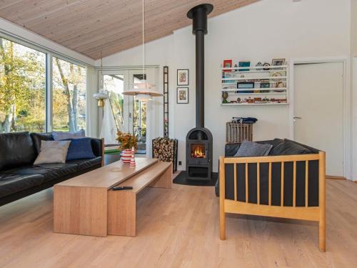 een woonkamer met een bank en een houtkachel bij 8 person holiday home in Glesborg in Glesborg