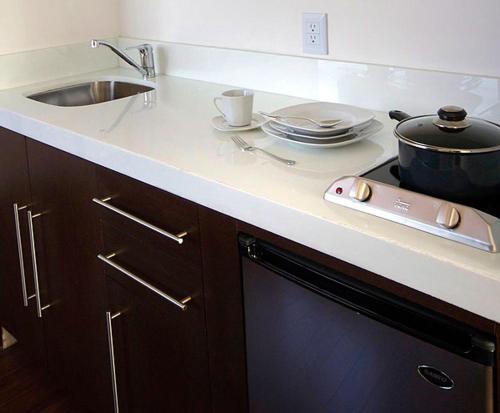 a kitchen counter with a sink and a pot on a stove at SUITES LONDRES 212 in Mexico City