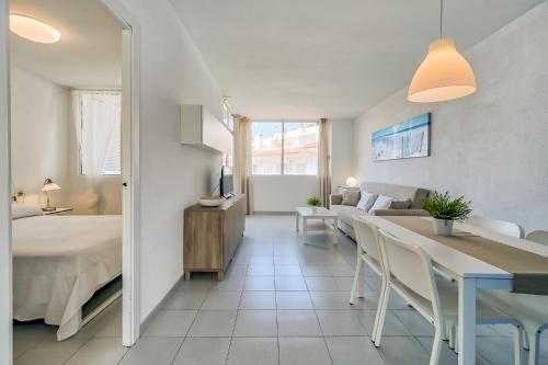 a bedroom and living room with a bed and a table at Hauzify I Apartaments Sot del Morer in San Pol de Mar