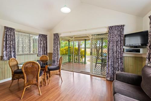a living room with a table and chairs at Discovery Parks - Lake Hume, Victoria in Bonegilla