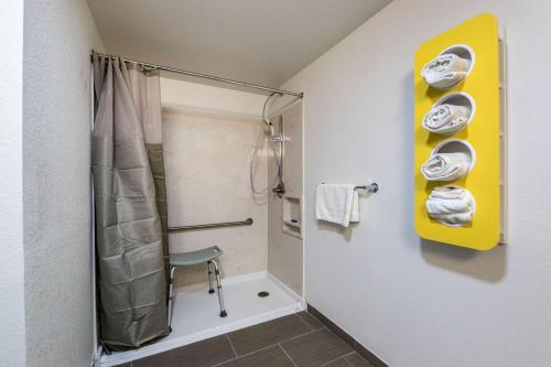 a bathroom with a shower with a shower curtain at Motel 6 Peoria in Peoria